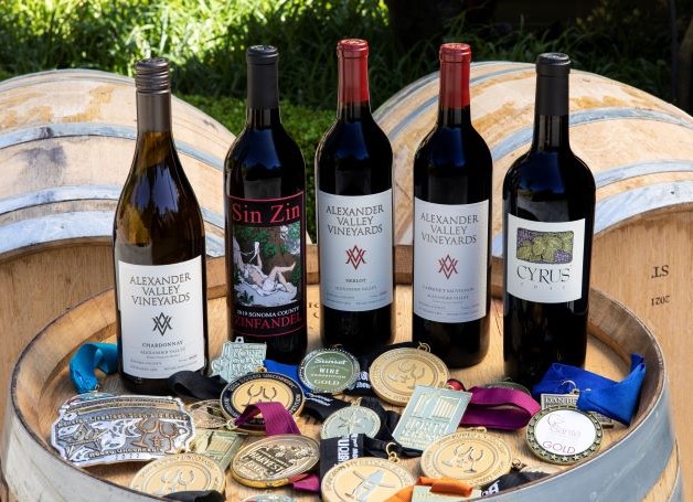 AVV Core Wines displayed with numerous award medals on wine barrel